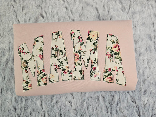 crew neck embroidered with a floral applique.