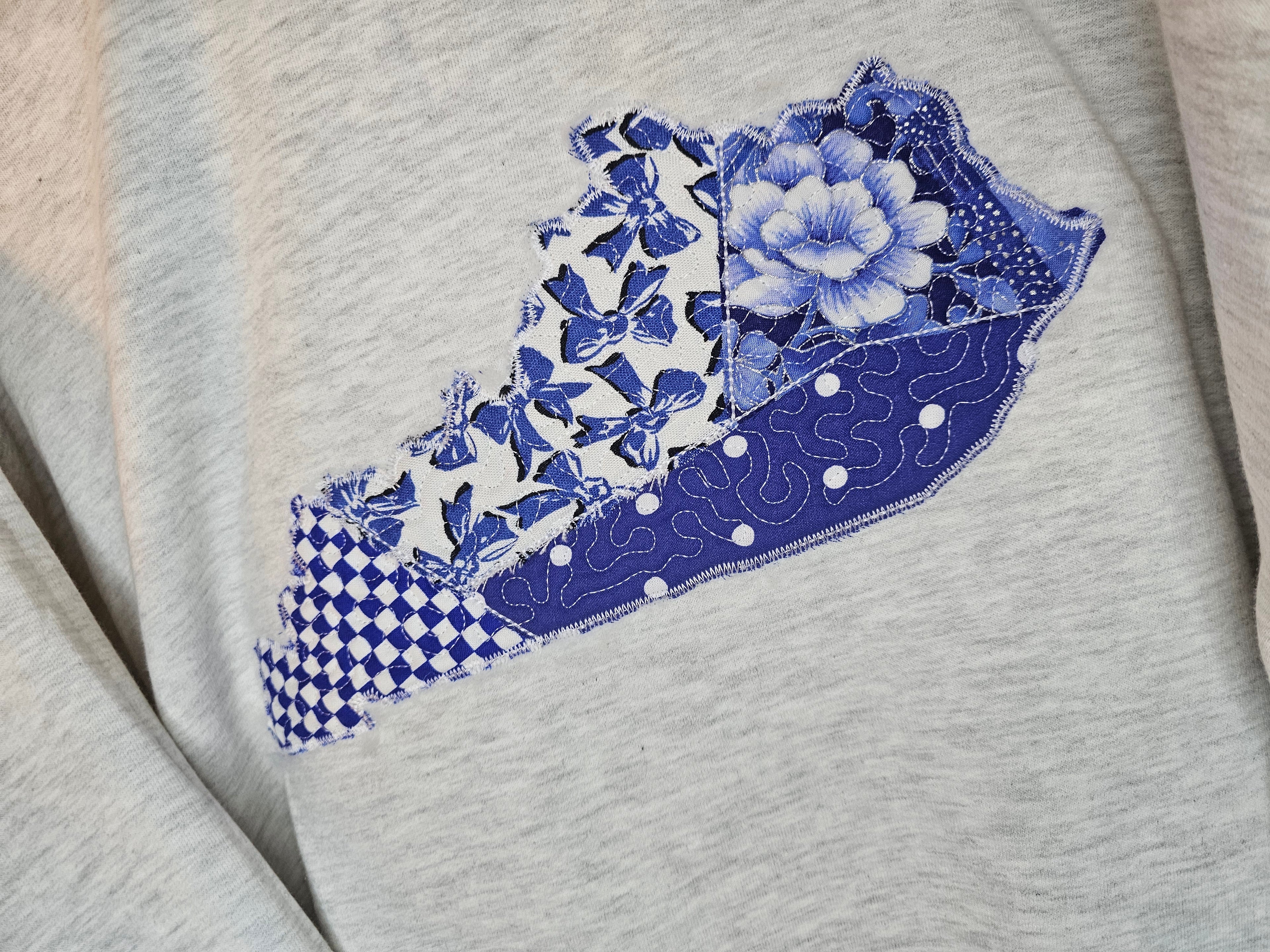 Quilted crewneck. Ky applique embroidered.