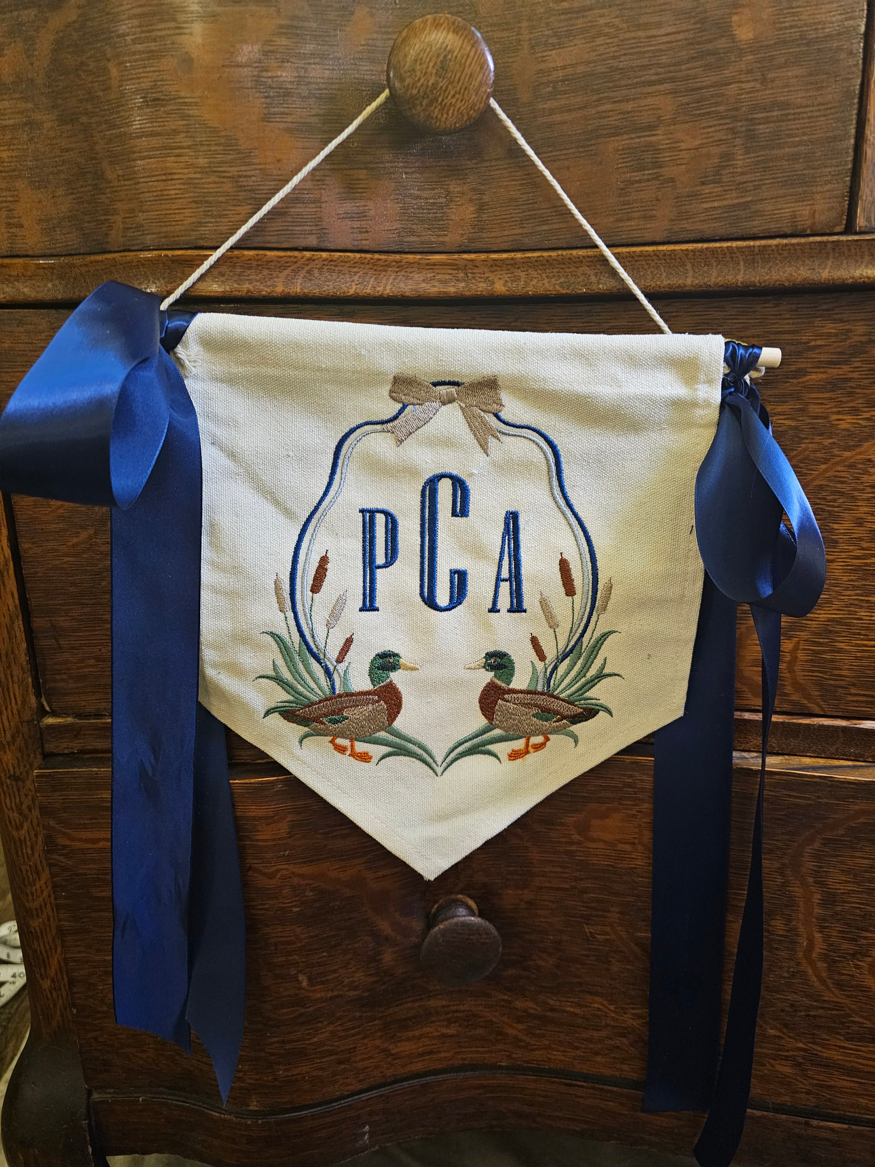 Monogrammed banner with bows.
